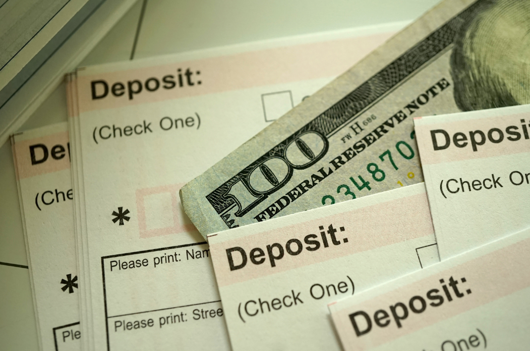 an image of checks and a US $100 bill