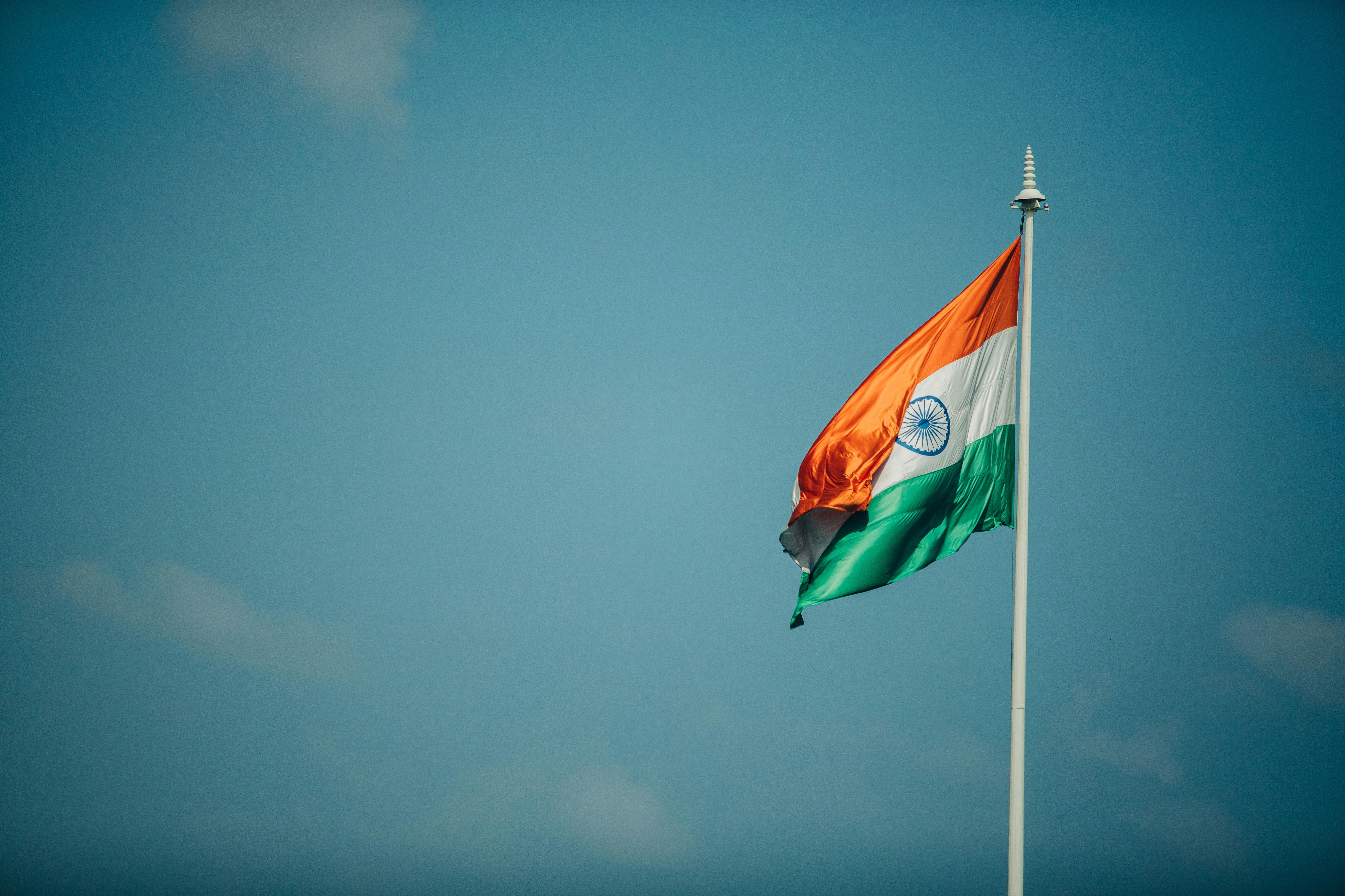 photo of the Indian flag with blue sky in the background