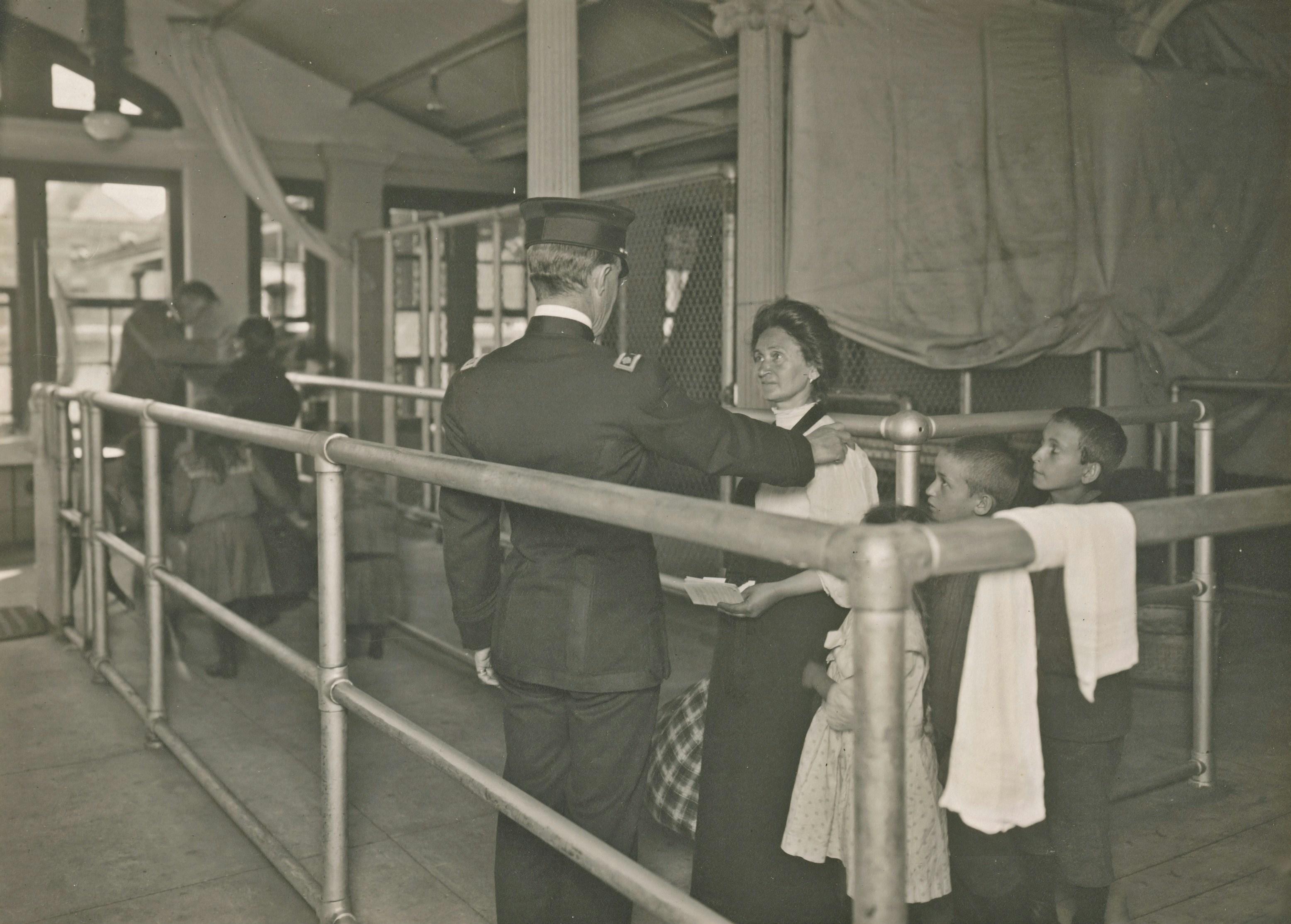 immigrants at Ellis Island undergoing medical inspection