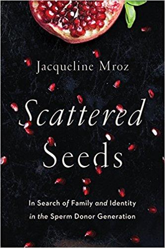 The image is of the cover of Jacqueline Mroz's "Scattered Seeds: In Search of Family and Identity in the Sperm Donor Generation," showcasing half of an open pomegranate at the top with pomegranate seeds scattered below against a black background.