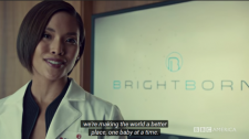 Female scientist in white lab coat stands in front of a screen with the words "BrightBorn"