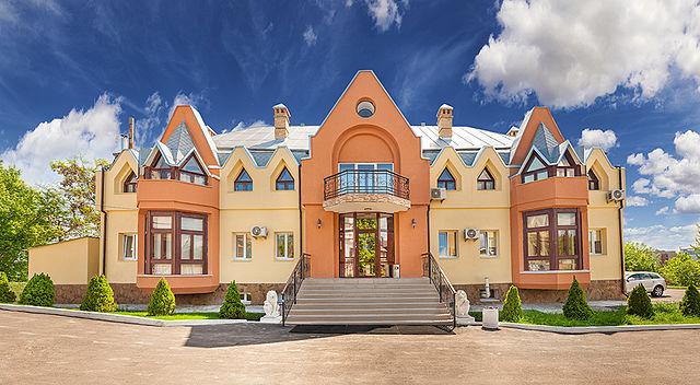 The many-gabled, bright terra cotta-colored facade of BioTexCom clinic