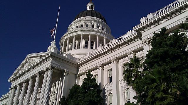 The dome and facade of the California state capitol building taken from a sharp upward angle