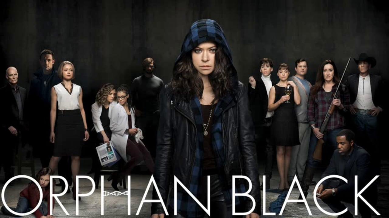 The cast of Orphan Black is dressed in character and lined against a darkened background. The main character is positioned in the middle, with a hood covering her head. The title, "Orphan Black" appears below the characters, with a double helix in the letter "H."
