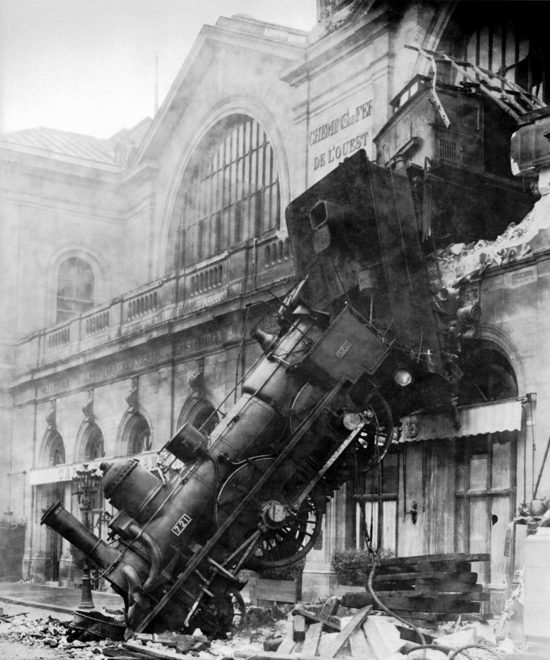 Black and white image of a runaway train that crashed into a building in Montparnasse