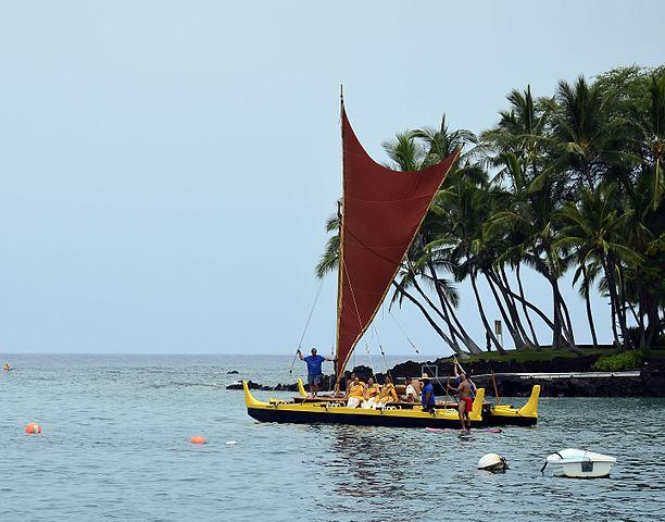 Hawaiian double hulled sailing canoe setting out on ceremonial voyage