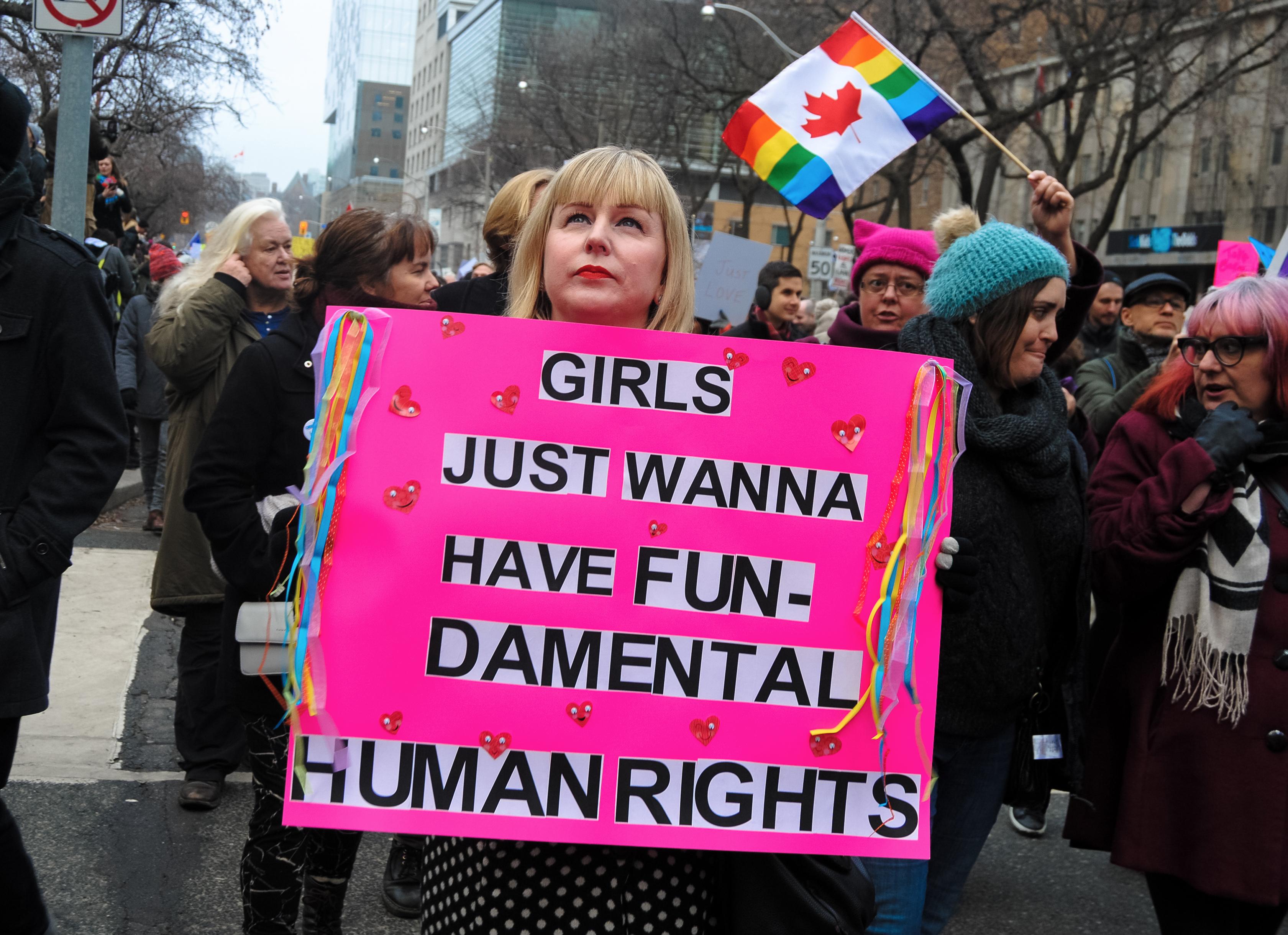 A woman holds a sign that reads "Woman just want to have fundamental human rights" at the Toronto Women's March in 2017.