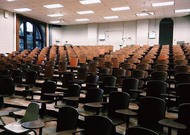 Image taken from the front of a lecture hall facing the empty seats. 