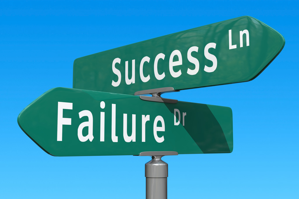 street signs reading "Success Ln" and "Failure Dr"