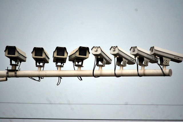 Several video surveillance cameras are lined up in different angles on a wall