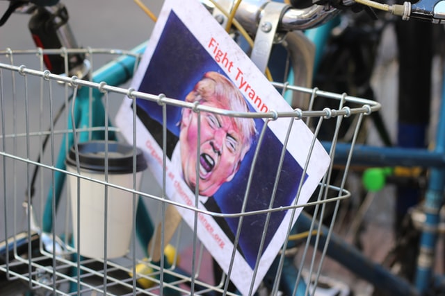 Trump on sign in bicycle basket