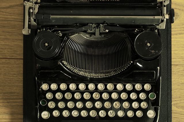 Bird's eye view of an old typewriter on a wooden desk.